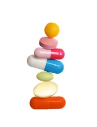 Photo of Stack of different colorful pills on white background