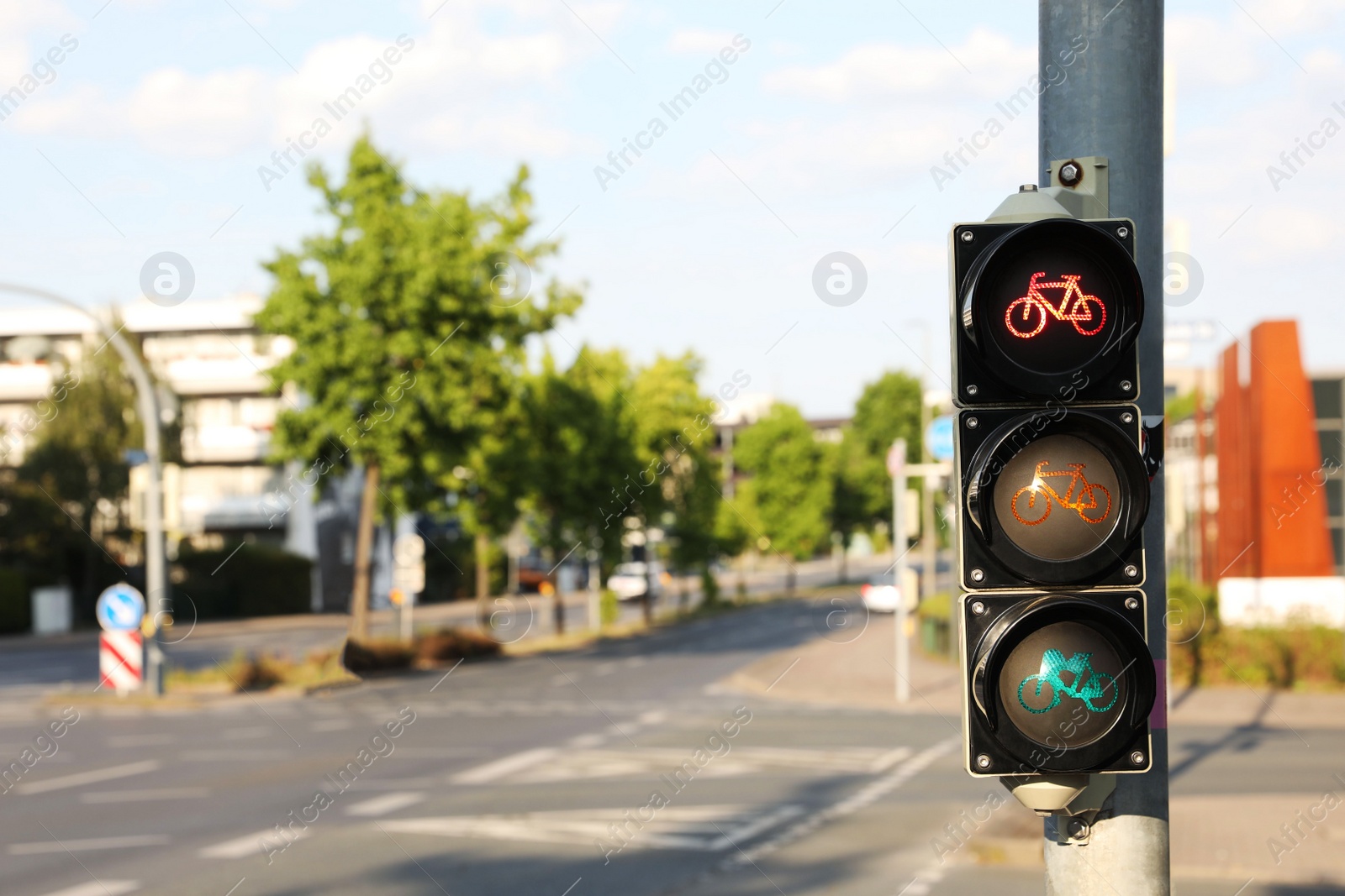 Photo of View of traffic light for bikes near road in city. Space for text