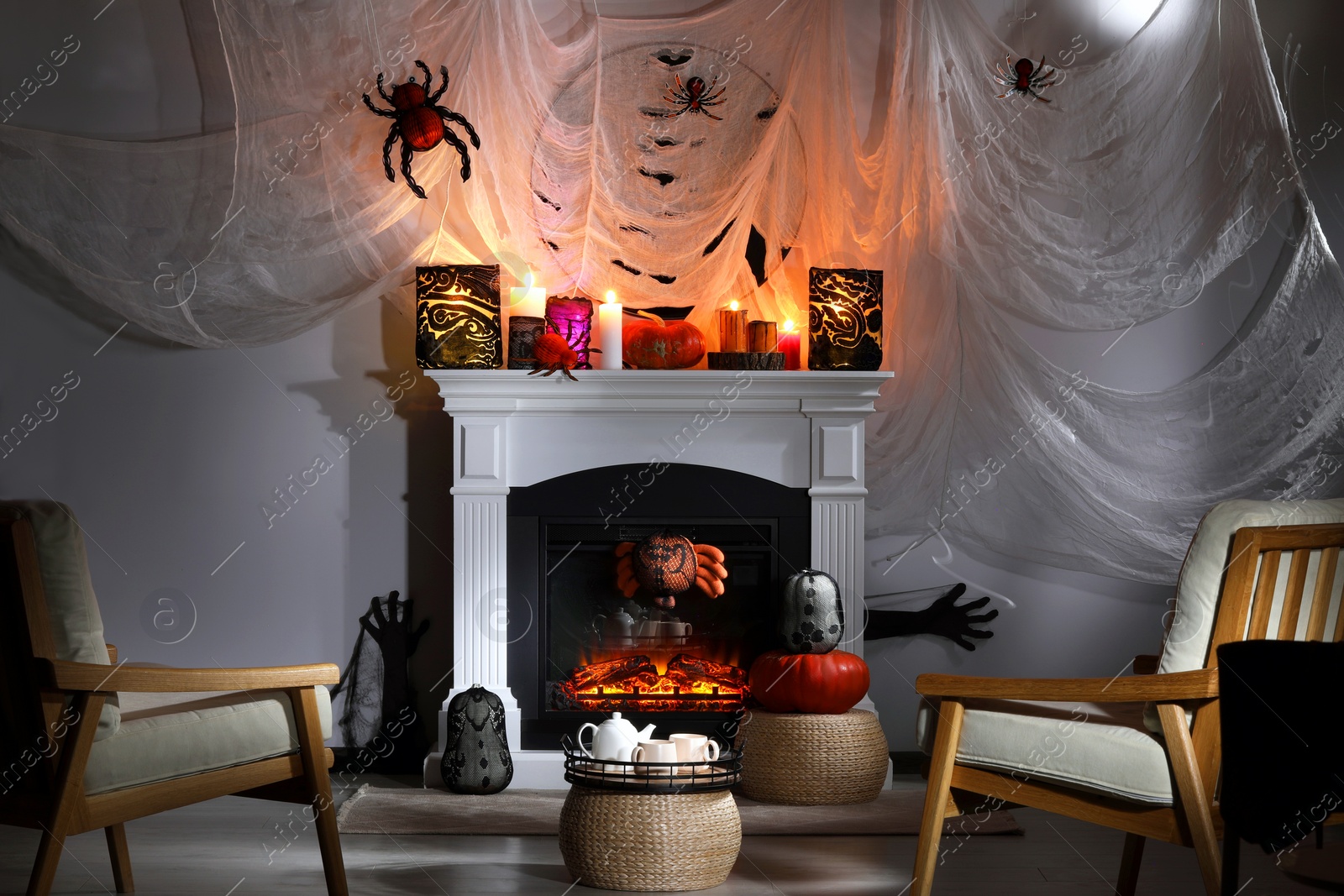 Photo of Room with fireplace decorated for Halloween. Festive interior