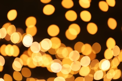 Beautiful golden lights on dark background. Bokeh effect