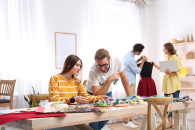 Fashion designers creating new clothes in studio