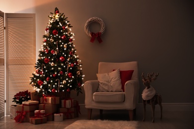 Photo of Beautiful decorated Christmas tree in living room. Festive interior