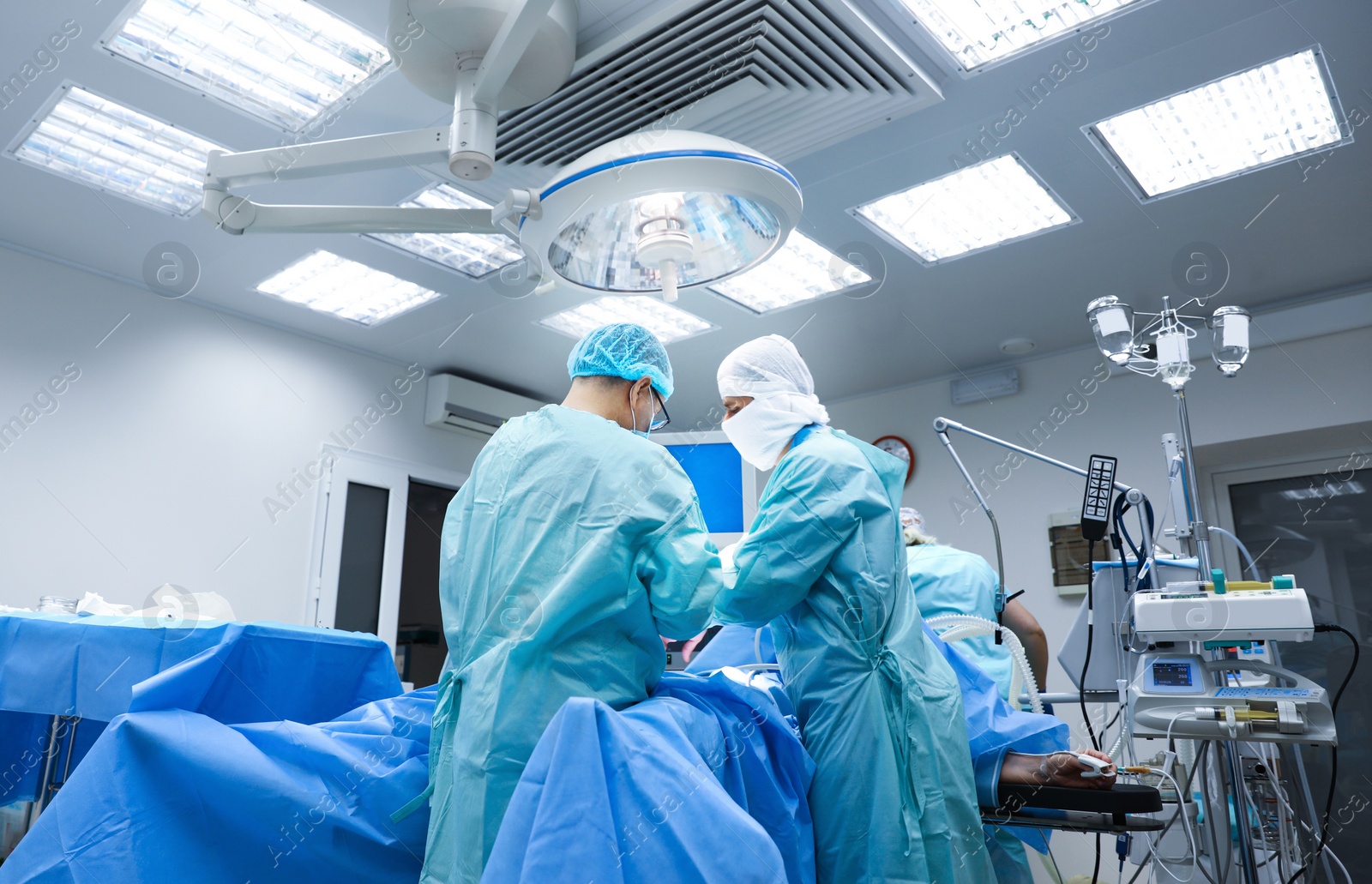 Photo of Medical team performing surgery in operating room