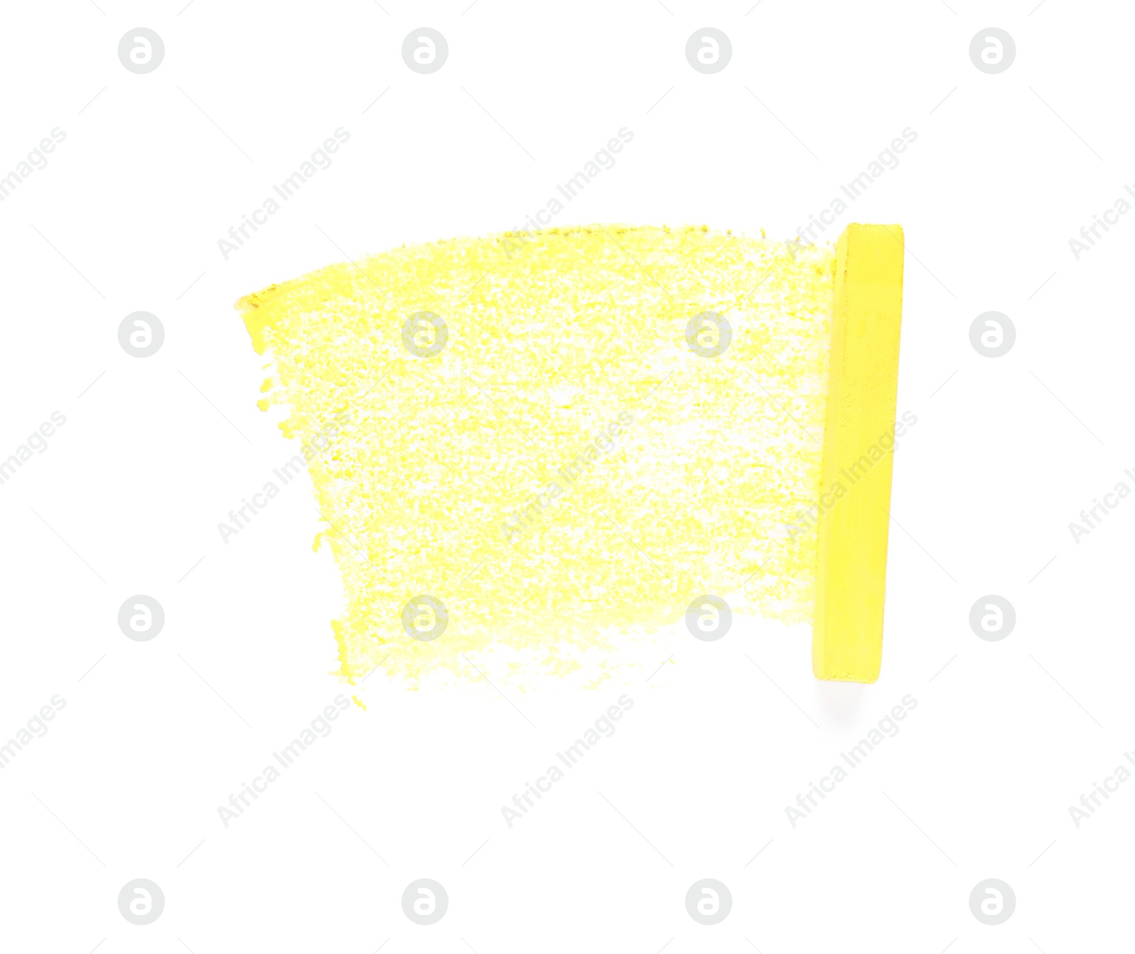 Photo of Yellow pastel chalk on sheet of paper with scribble, top view. Drawing material