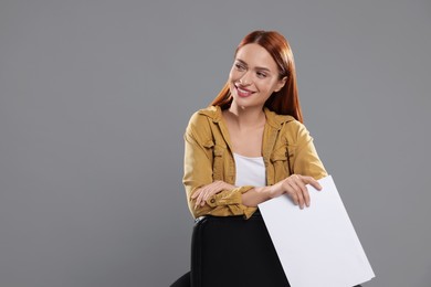 Photo of Casting call. Young woman with script on chair against grey background, space for text