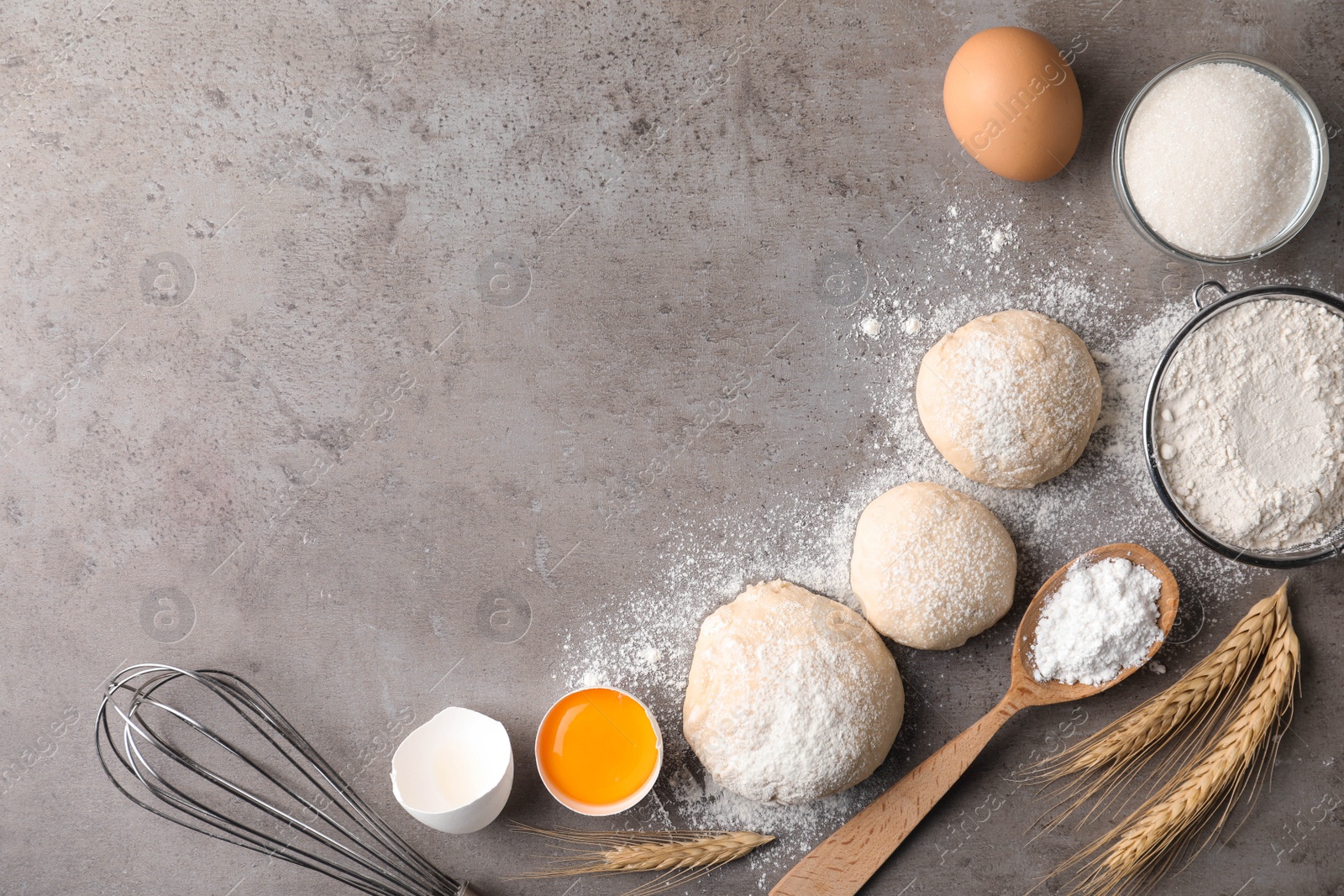 Photo of Flat lay composition with dough on grey table, space for text. Cooking pastries