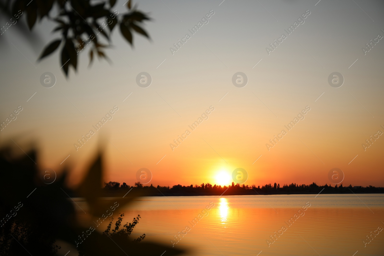 Photo of Picturesque view of tranquil river at sunset