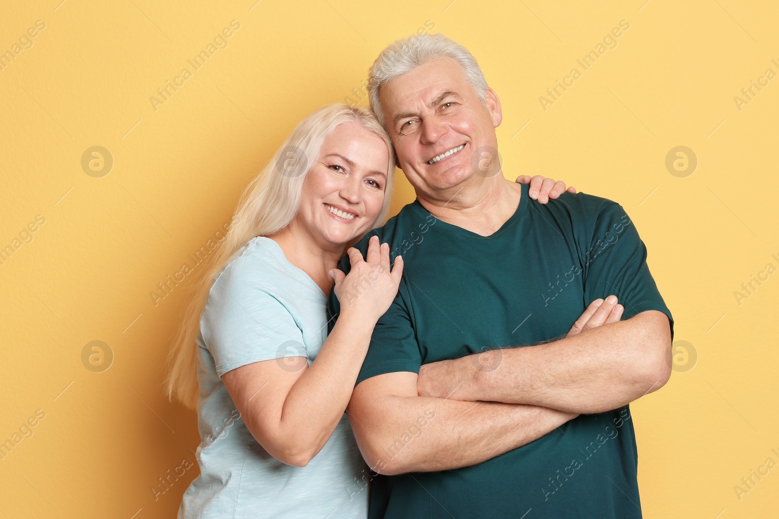 Photo of Portrait of adorable mature couple against color background