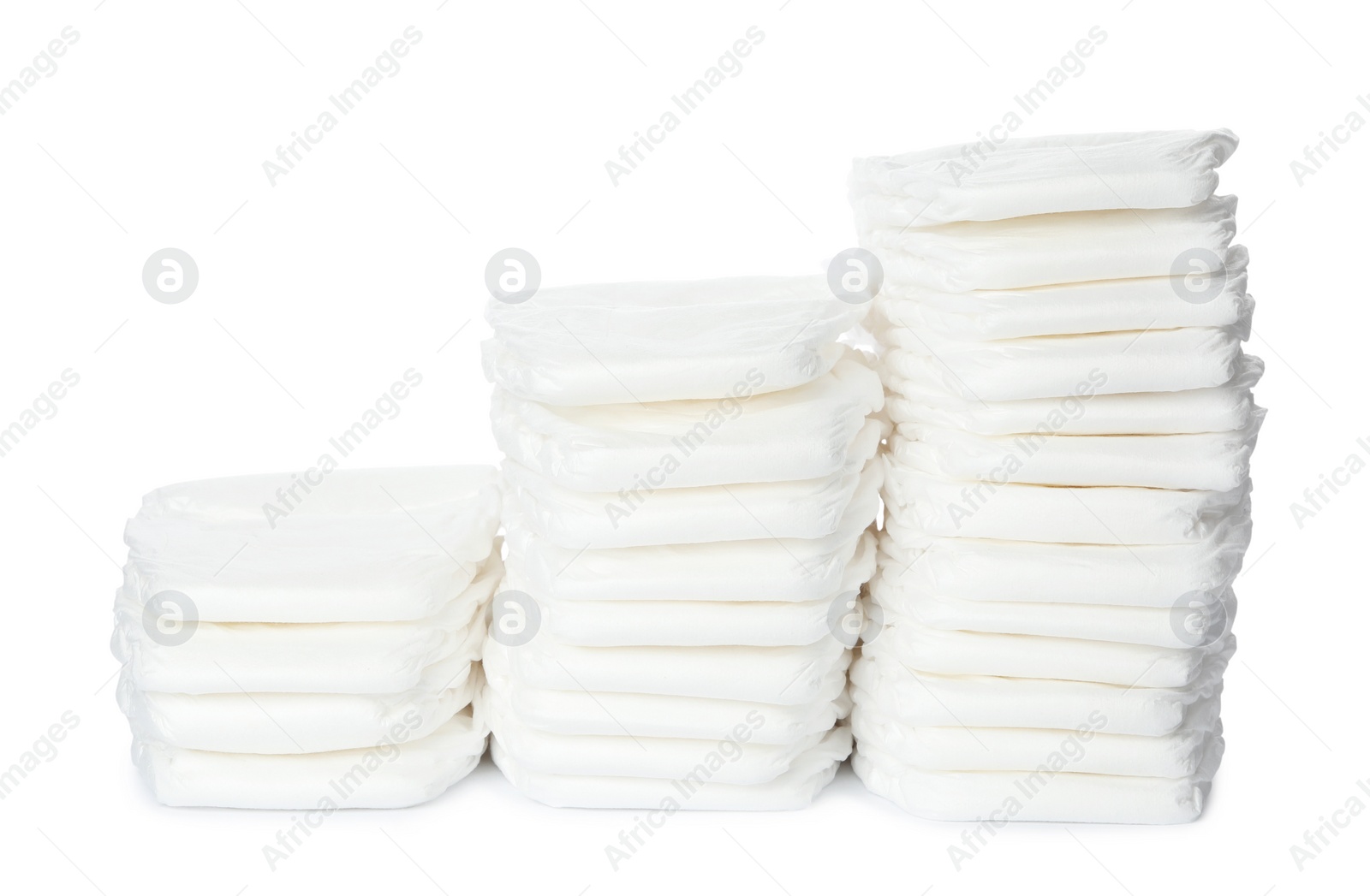 Photo of Stacks of baby diapers isolated on white