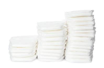 Photo of Stacks of baby diapers isolated on white