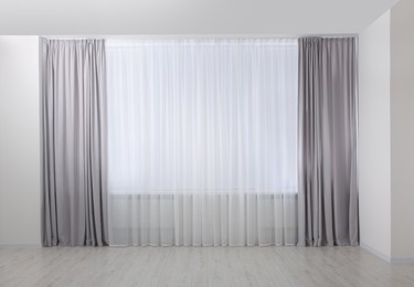 Light grey window curtains and white tulle indoors