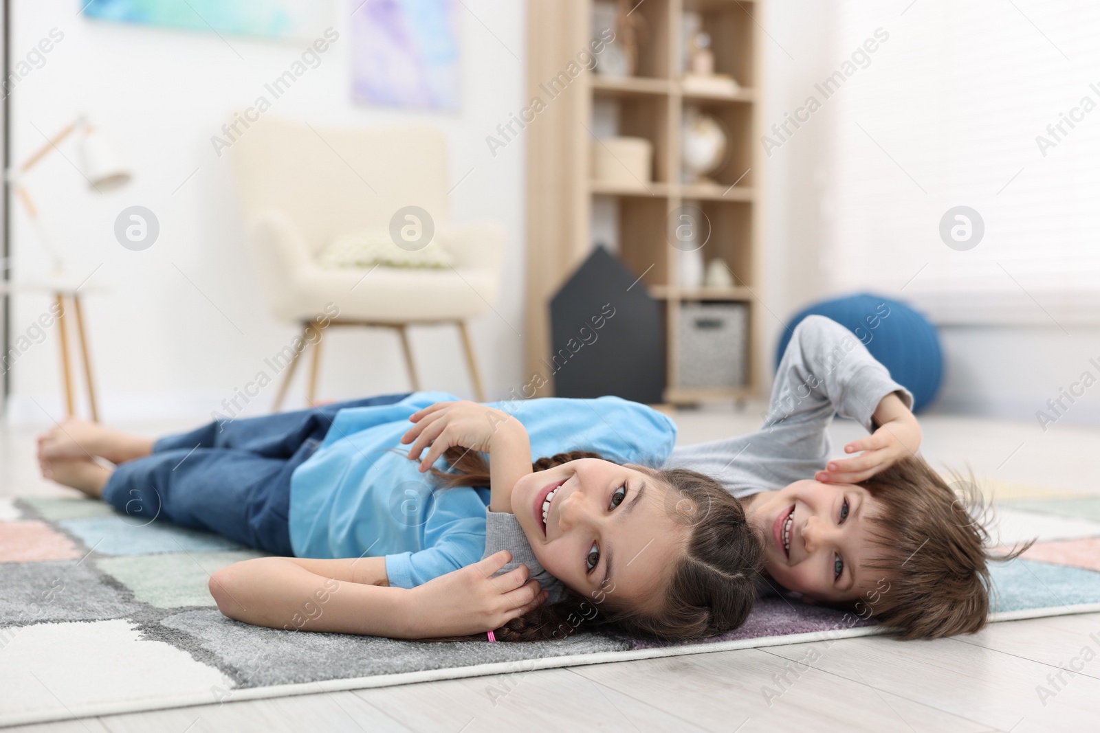 Photo of Happy brother and sister spending time together at home