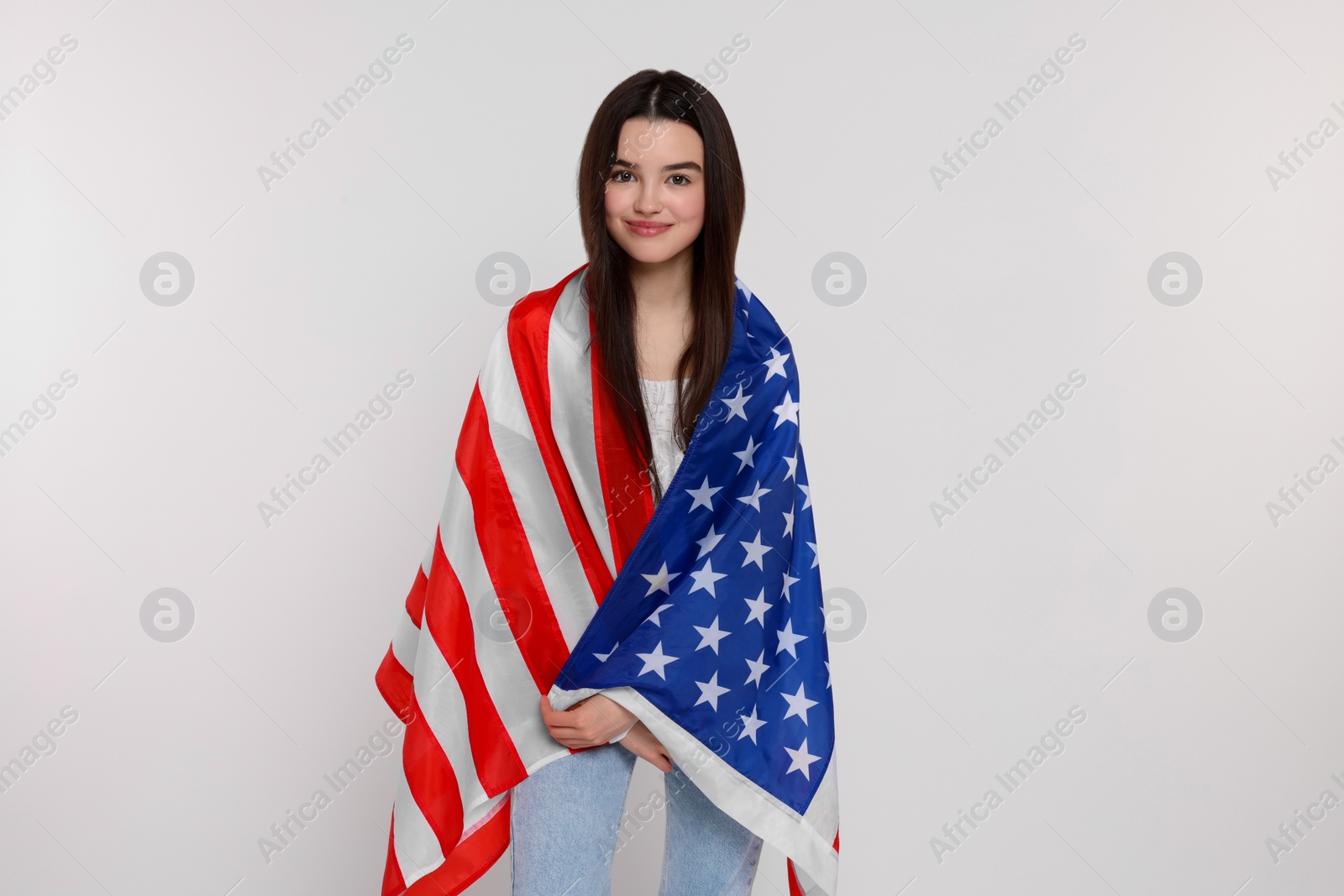 Photo of 4th of July - Independence Day of USA. Happy girl with American flag on white background