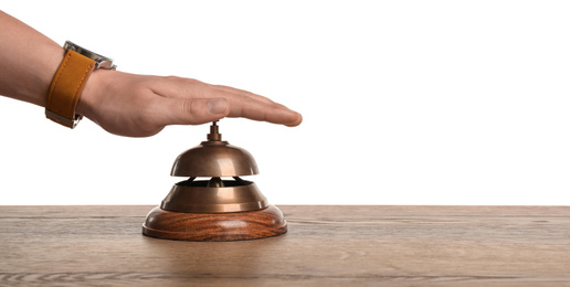 Man ringing hotel service bell at wooden table