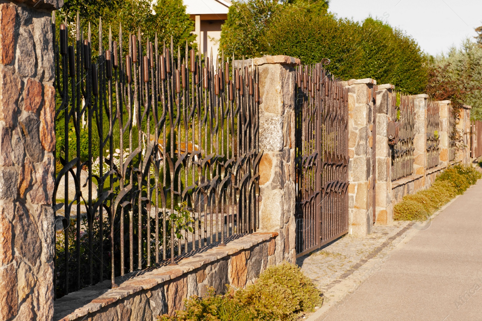 Photo of Beautiful iron fence on sunny day outdoors