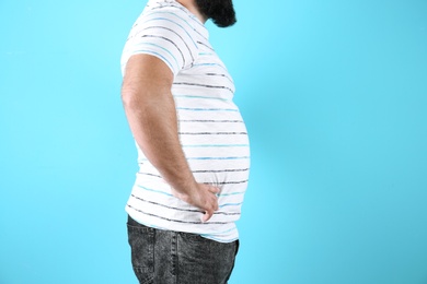 Photo of Fat man on color background, space for text. Weight loss