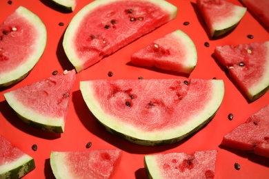 Photo of Slices of ripe watermelon on red background, closeup