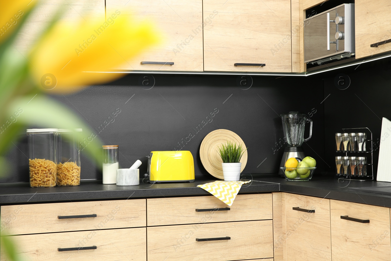 Photo of Kitchen interior with new furniture, appliances and houseware