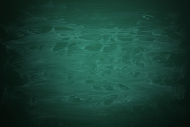 Dirty green chalkboard as background. Vignette effect