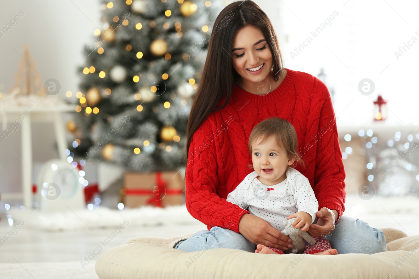 Photo of Mother and her cute baby at home. Christmas celebration