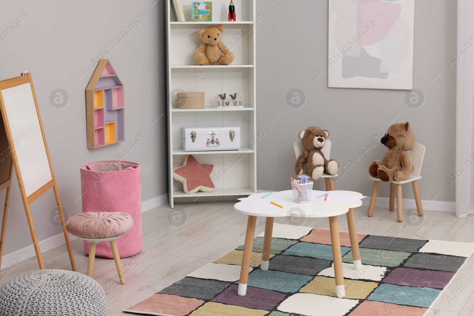 Photo of Child`s playroom with different toys and modern furniture. Stylish kindergarten interior