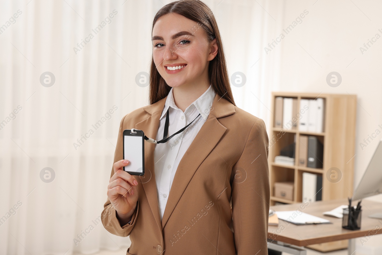 Photo of Happy woman with blank badge in office