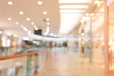 Photo of Blurred view of modern shopping mall interior. Bokeh effect