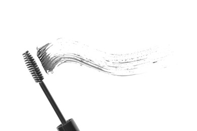 Photo of Smear of mascara and applicator isolated on white, top view