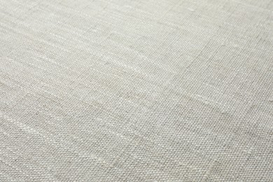 Photo of Texture of light grey fabric as background, closeup