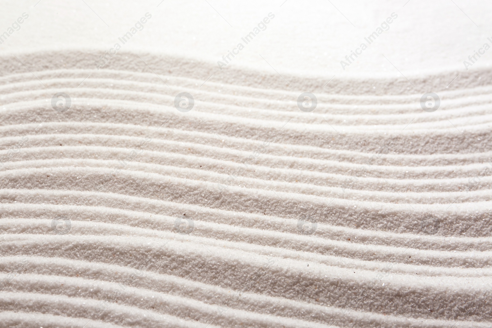 Photo of Zen rock garden. Wave pattern on white sand