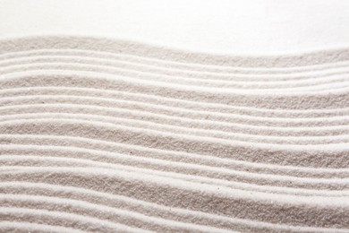 Photo of Zen rock garden. Wave pattern on white sand