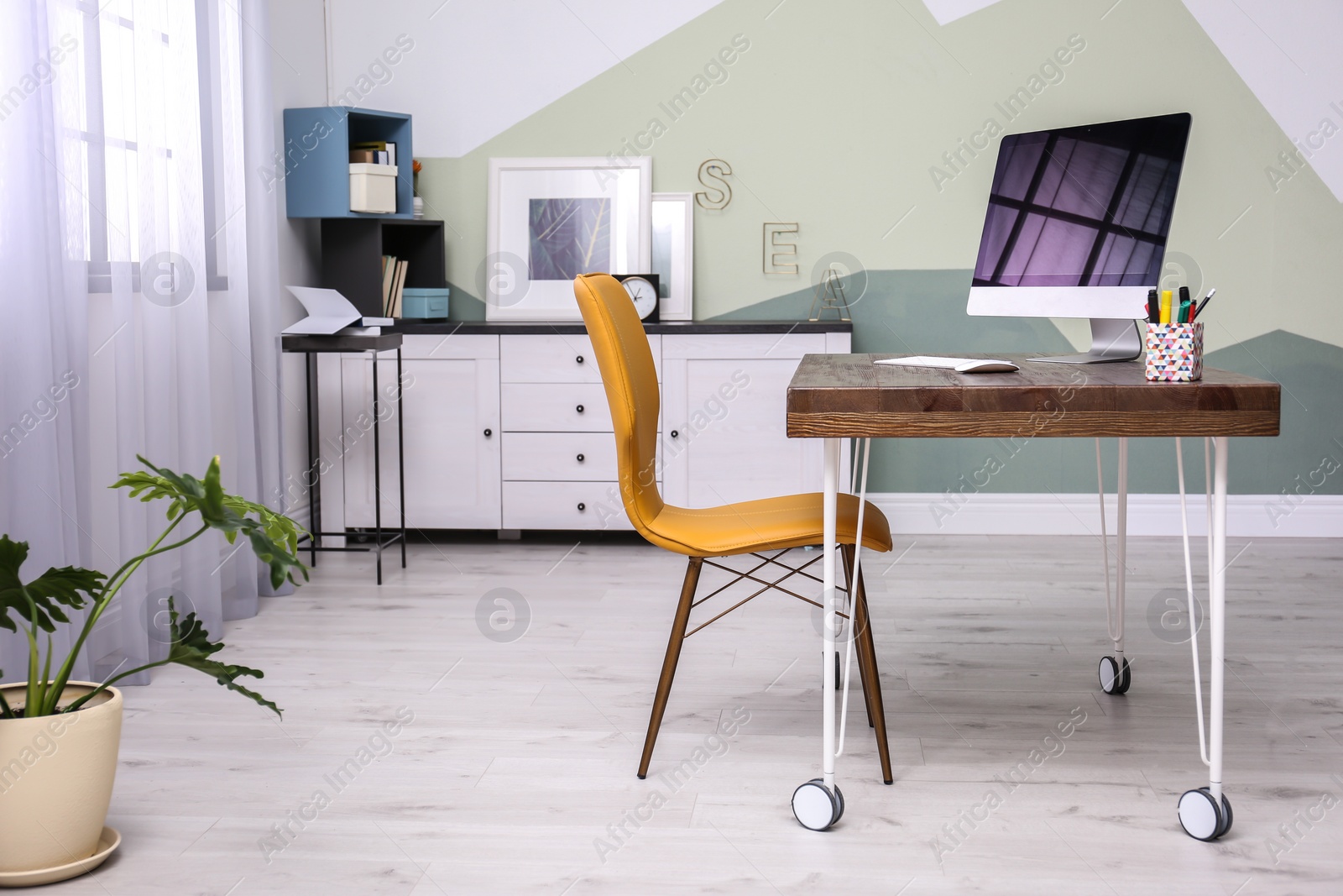 Photo of Comfortable workplace with computer on desk in home office