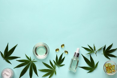 Flat lay composition with CBD oil or THC tincture and hemp leaves on light blue background, space for text