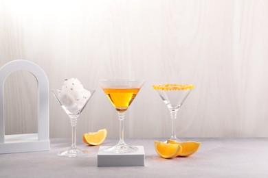 Cotton candy and cocktails in glasses on gray table