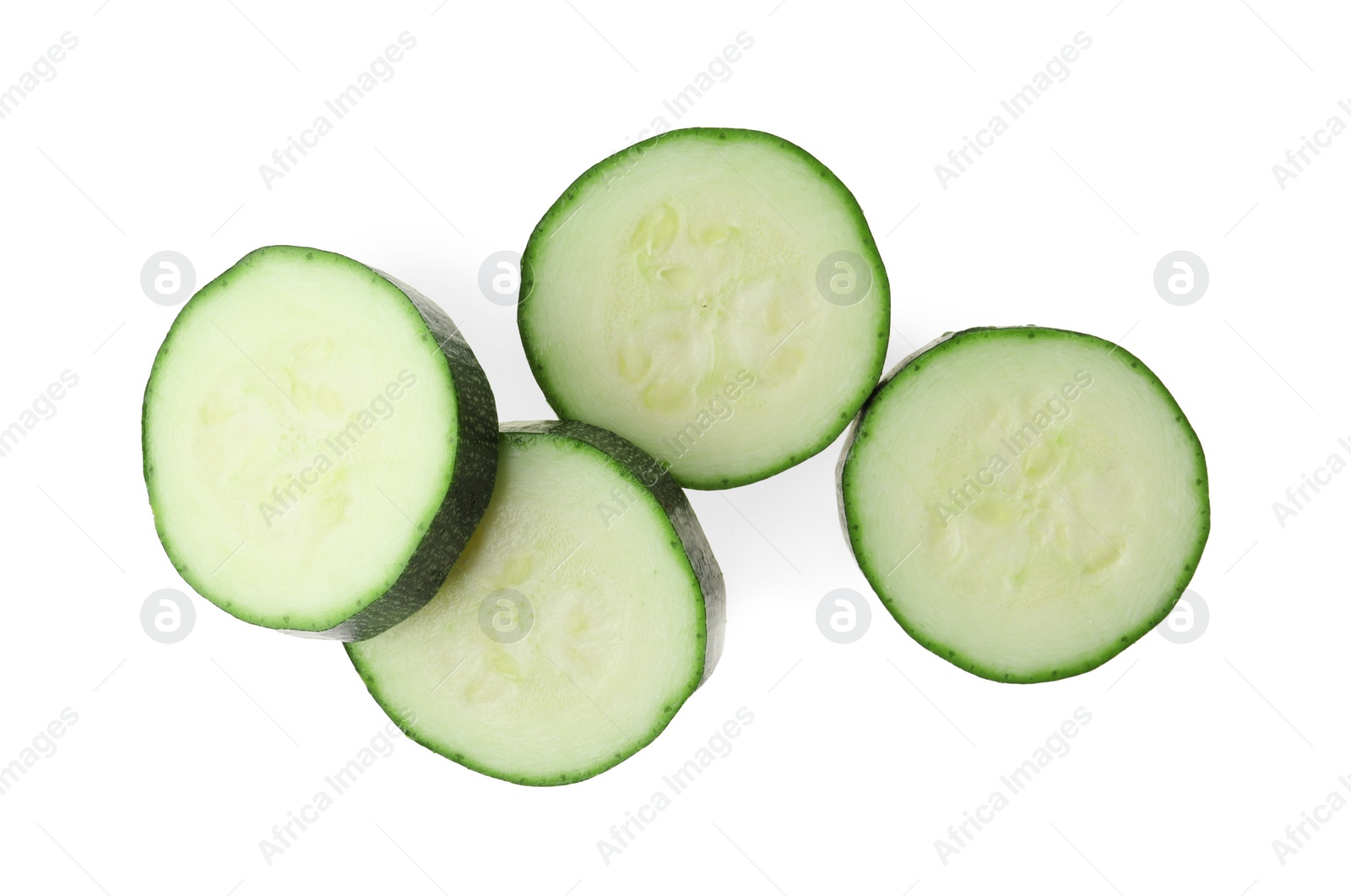 Photo of Slices of ripe zucchini on white background, top view