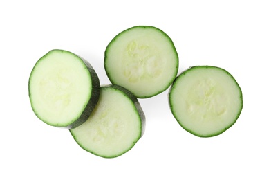 Slices of ripe zucchini on white background, top view