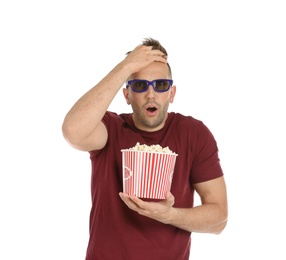Emotional man with 3D glasses and popcorn during cinema show on white background