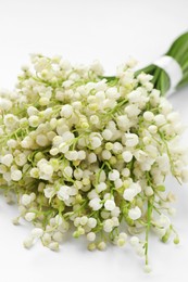 Photo of Beautiful lily of the valley bouquet on white background, closeup