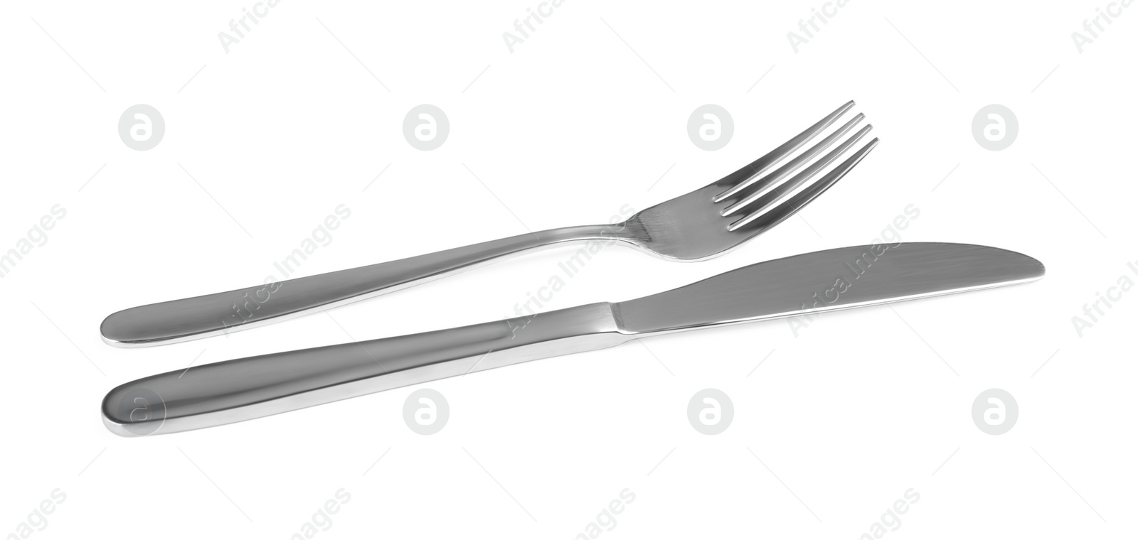 Photo of Shiny fork and knife on white background