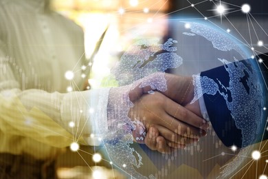 Deal or partnership concept. Double exposure with globe, charts and photo of businesspeople shaking hands