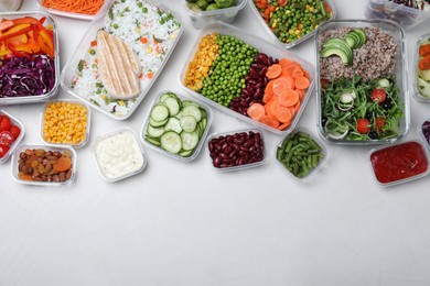Photo of Set of containers with fresh food on white table, flat lay. Space for text
