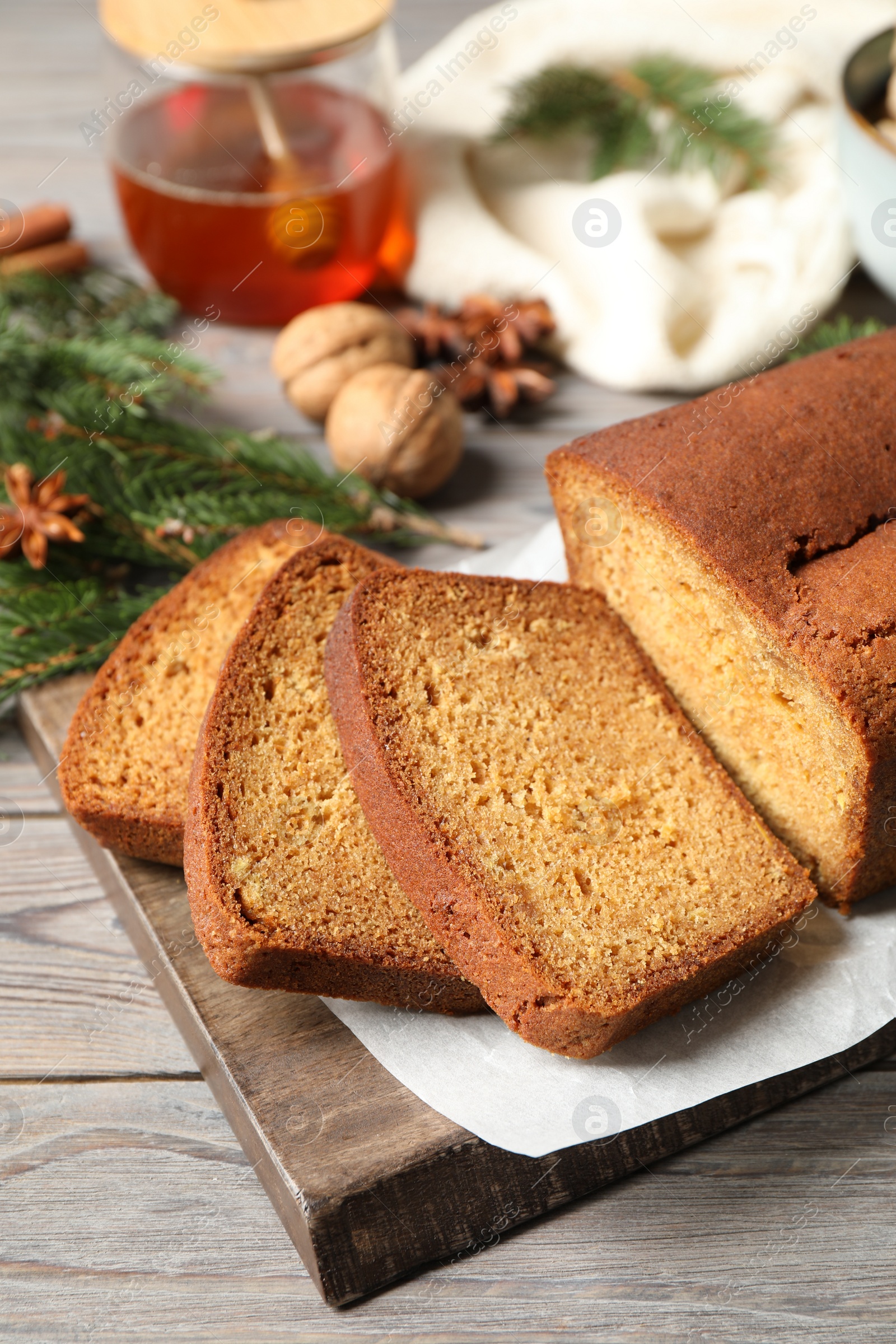 Photo of Fresh sliced gingerbread cake on wooden table