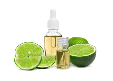 Photo of Lime essential oil in bottles and citrus fruits isolated on white