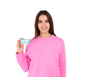 Happy young woman with driving license on white background