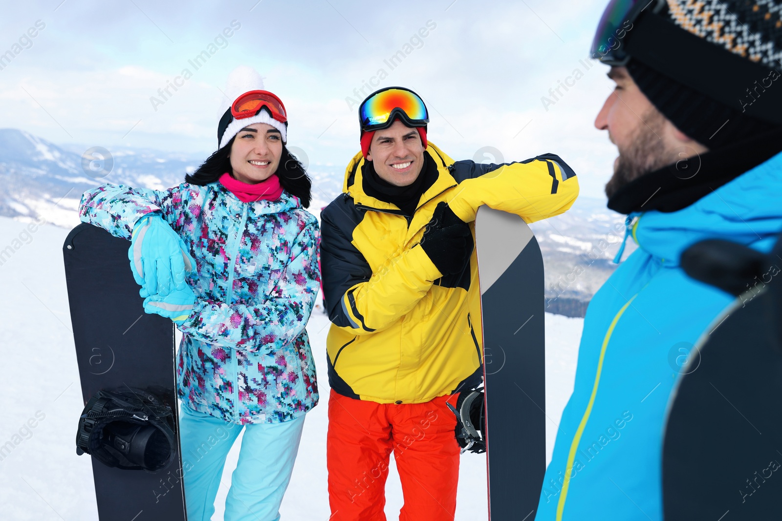 Photo of Group of friends with equipment in snowy mountains. Winter vacation