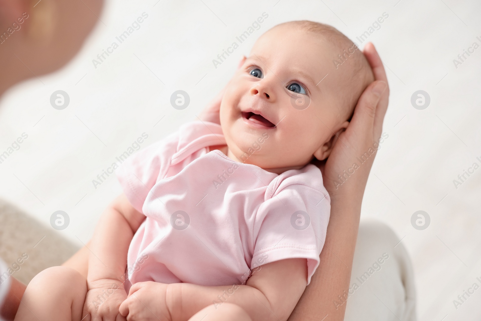 Photo of Mother with her cute little baby at home