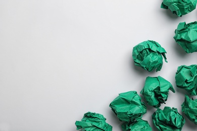 Photo of Color crumpled sheets of paper on white background, top view