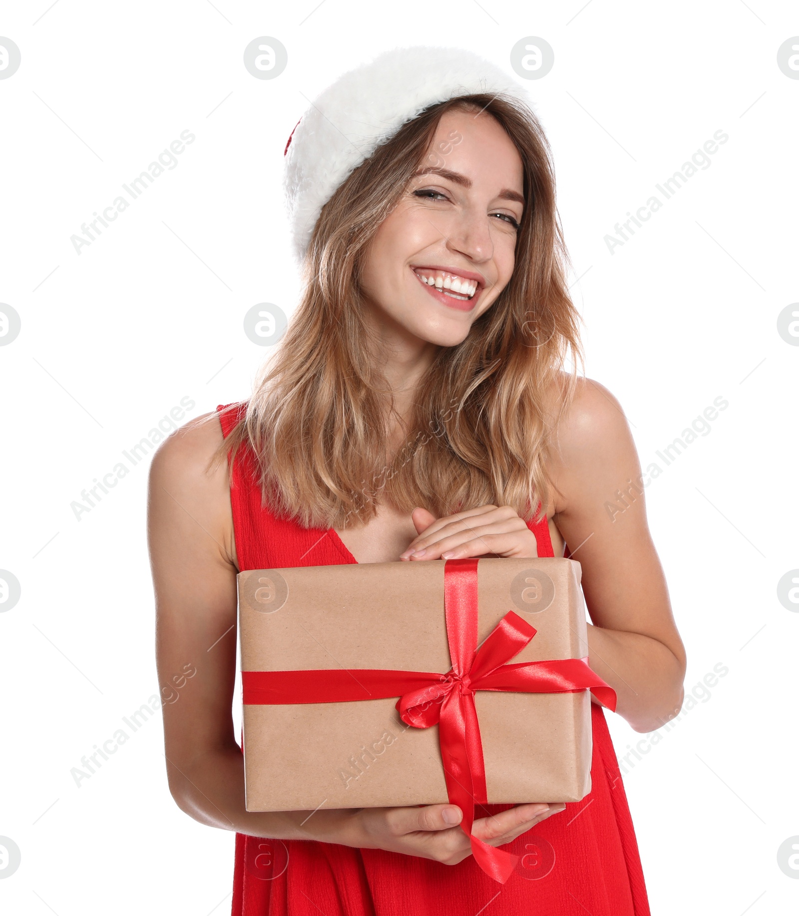 Photo of Happy young woman in Santa hat with gift box on white background. Christmas celebration