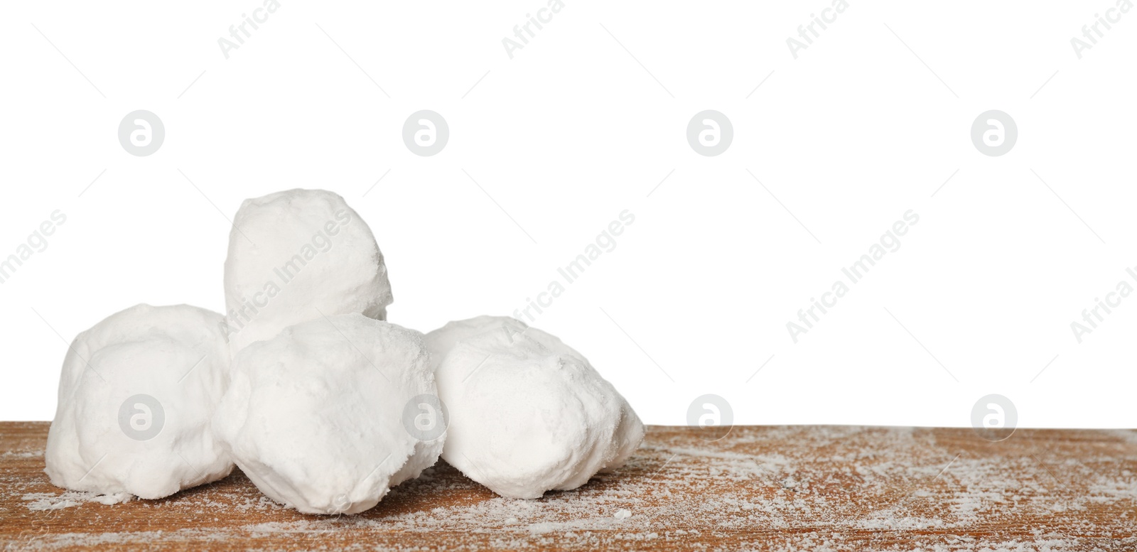 Photo of Snowballs on wooden table against white background. Space for text