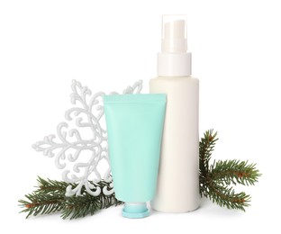 Photo of Set of cosmetic products with hand cream and Christmas decor isolated on white. Winter skin care